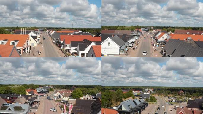奥克斯比购物街的航拍画面。飞越在沿海小镇中心漫步的人们。暑假目的地。丹麦