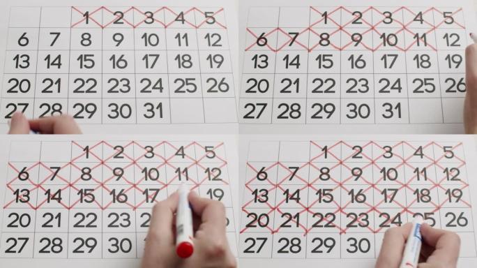 人的手用红笔在纸质日历上写下一整天。