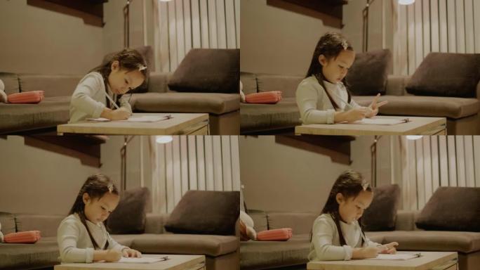 亚洲女孩在她的公寓做数学作业。