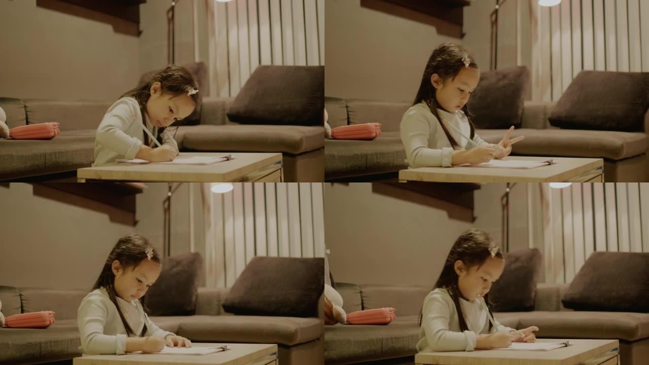 亚洲女孩在她的公寓做数学作业。