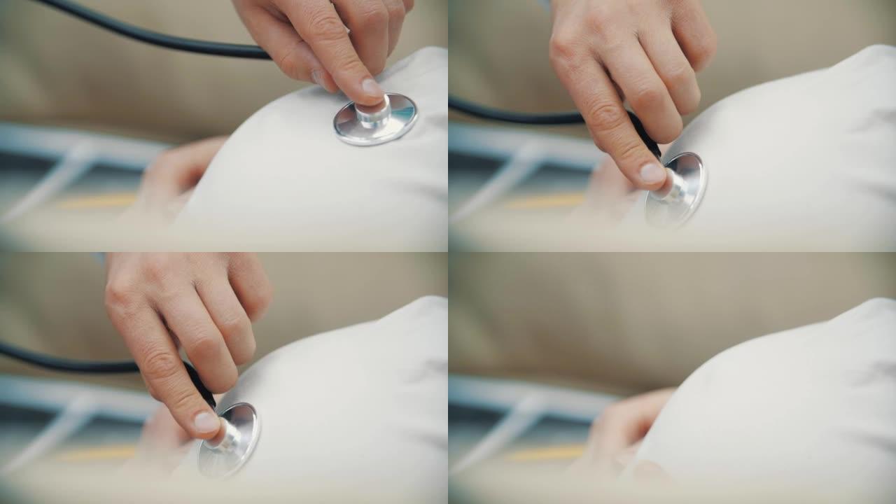 孕妇胃部用听诊器裁剪医生手的4k慢动作视频。