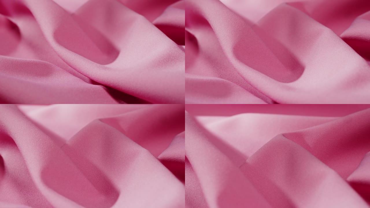 粉色面料特写，缎面奢华布料纹理背景。豪华设计纺织品