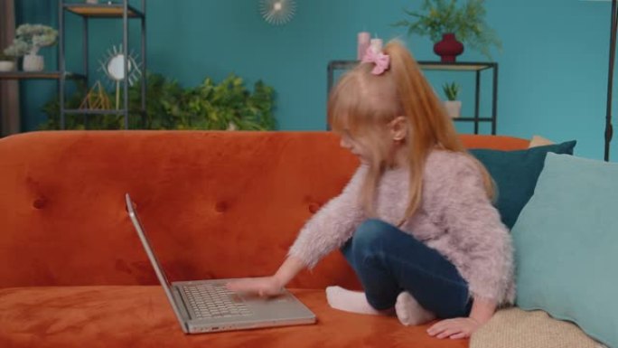 小学生女孩在家独自使用笔记本电脑学习阅读在线教育课程