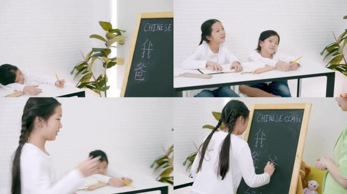 亚洲年轻的女老师在汉语课上教学和提问，而两个小学女生正试图举手回答问题。年轻的亚洲女孩在黑板上学习汉