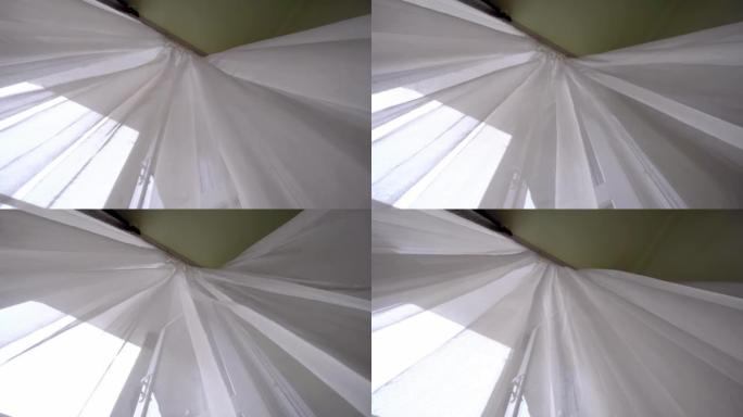 窗户上的透明窗帘，在房间的风中微微摇曳。