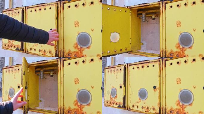 高加索男性技术人员在危机期间打开与管道网络断开连接的住宅建筑物墙壁上的空燃气表箱