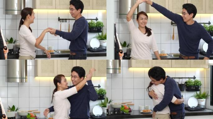 亚洲夫妇在厨房做健康食品时跳舞。居家生活方式与健康生活方式、快乐生活理念
