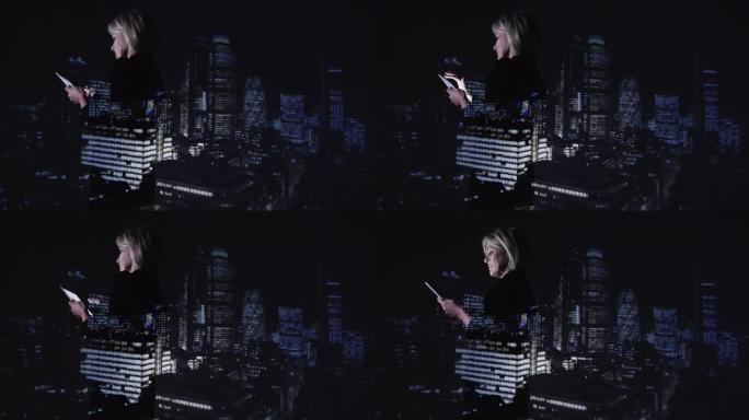 夜间使用数字平板电脑对抗城市天际线的双重曝光女商人