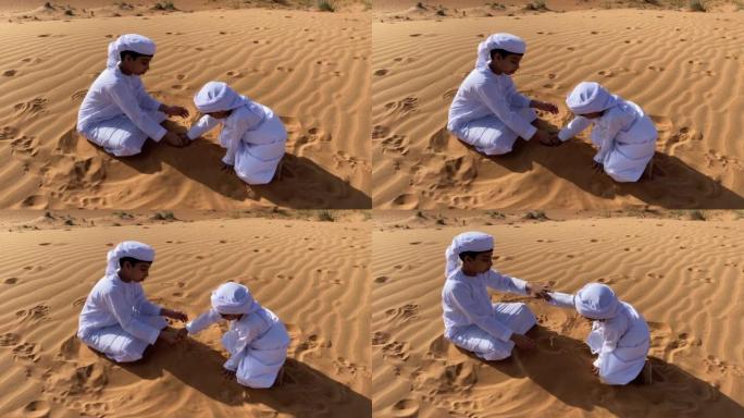两个在沙漠中玩耍的Emarati孩子