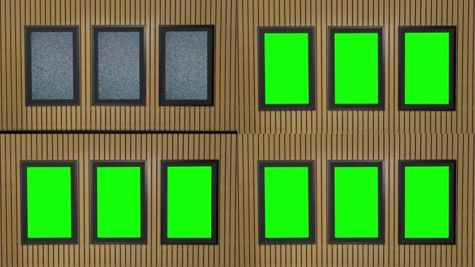 安装在木墙中的三个垂直LED电视屏幕显示模拟电视噪声，然后打开绿色屏幕色度键。放大，垂直视频模板，复