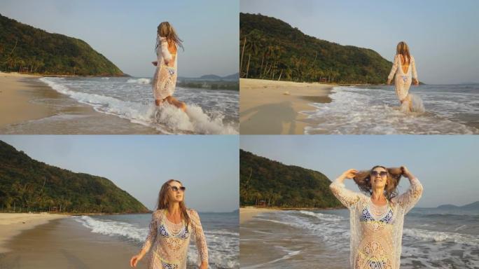 女人在海边的海滩上穿着白色上衣。戴着太阳镜的金发女郎。游客享受假期，在水上奔跑，散步很有趣