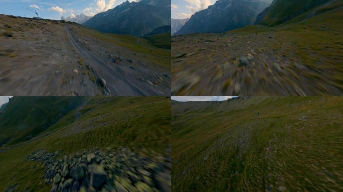 FPV无人机顶拍高山山谷自然丘陵地形与乡村小路绿草草坪山
