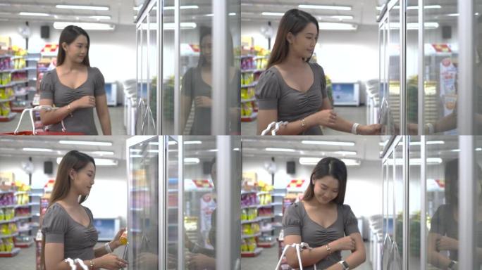 在超市购物。女人比较产品。女人从冰箱杂货店挑选物品