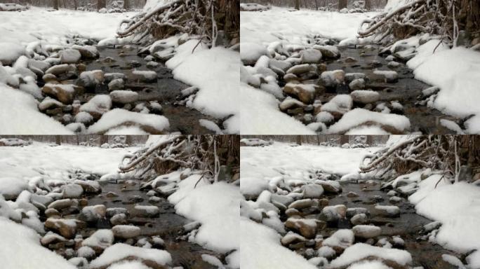 冬天雪中的一条小溪。