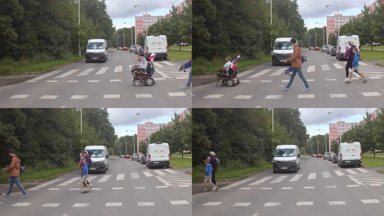 坐轮椅的人过马路。残疾人的社会包容。