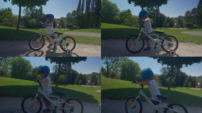 孩子走下自行车，在公园里骑自行车
