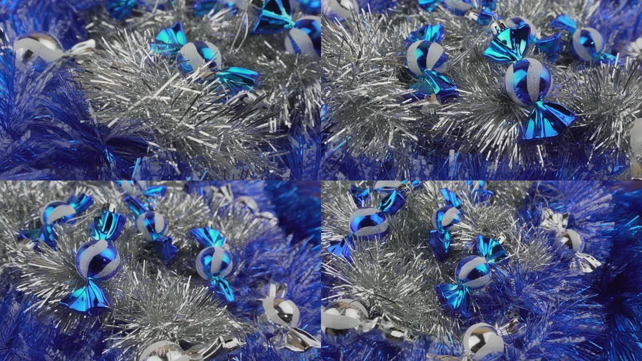 闪亮的蓝色和白色糖果玩具在多色金属丝背景上旋转