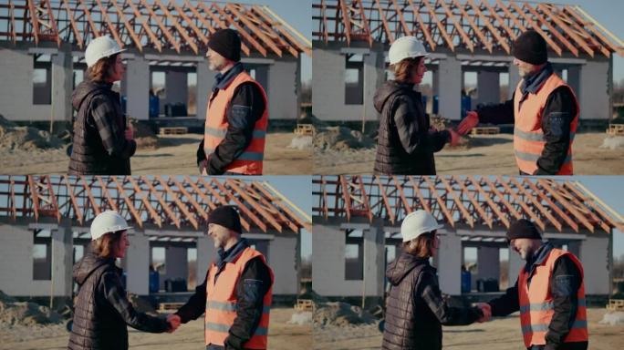 施工概念。投资者向投资的承包商致意。