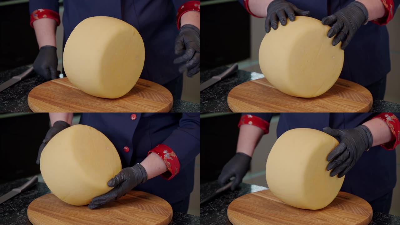 一名奶酪奶业工人检查煮熟的硬奶酪。在销售前评估产品的质量。