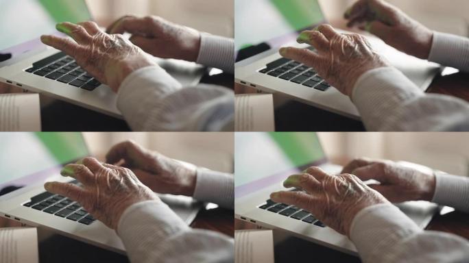 资深作者在时髦的笔记本电脑键盘上准备生活故事叙事打字项目的书版，皱巴巴的手用绿屏色键模拟在电脑上慢慢