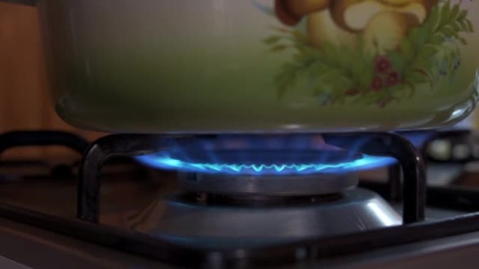 水壶在燃气燃烧器上加热。炉子上的炊具。