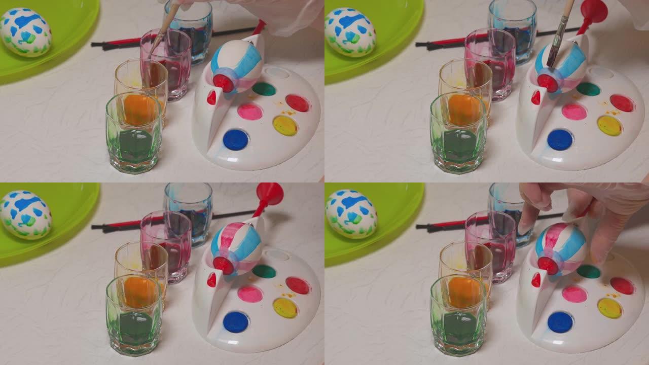 一个男孩学习用特殊器皿画复活节彩蛋的特写镜头。假日概念。瑞典。