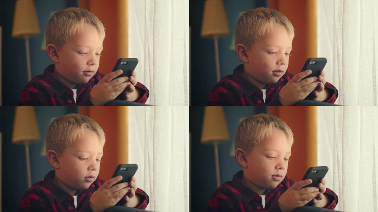 小男孩用智能手机玩游戏在家放松孩子用手机技术在线浏览防社交成瘾概念