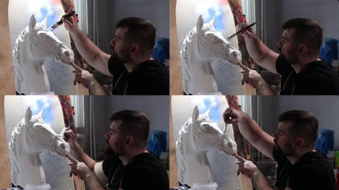 工匠根据石膏模型创造马。石膏模具和塑料面具雕刻和绘画