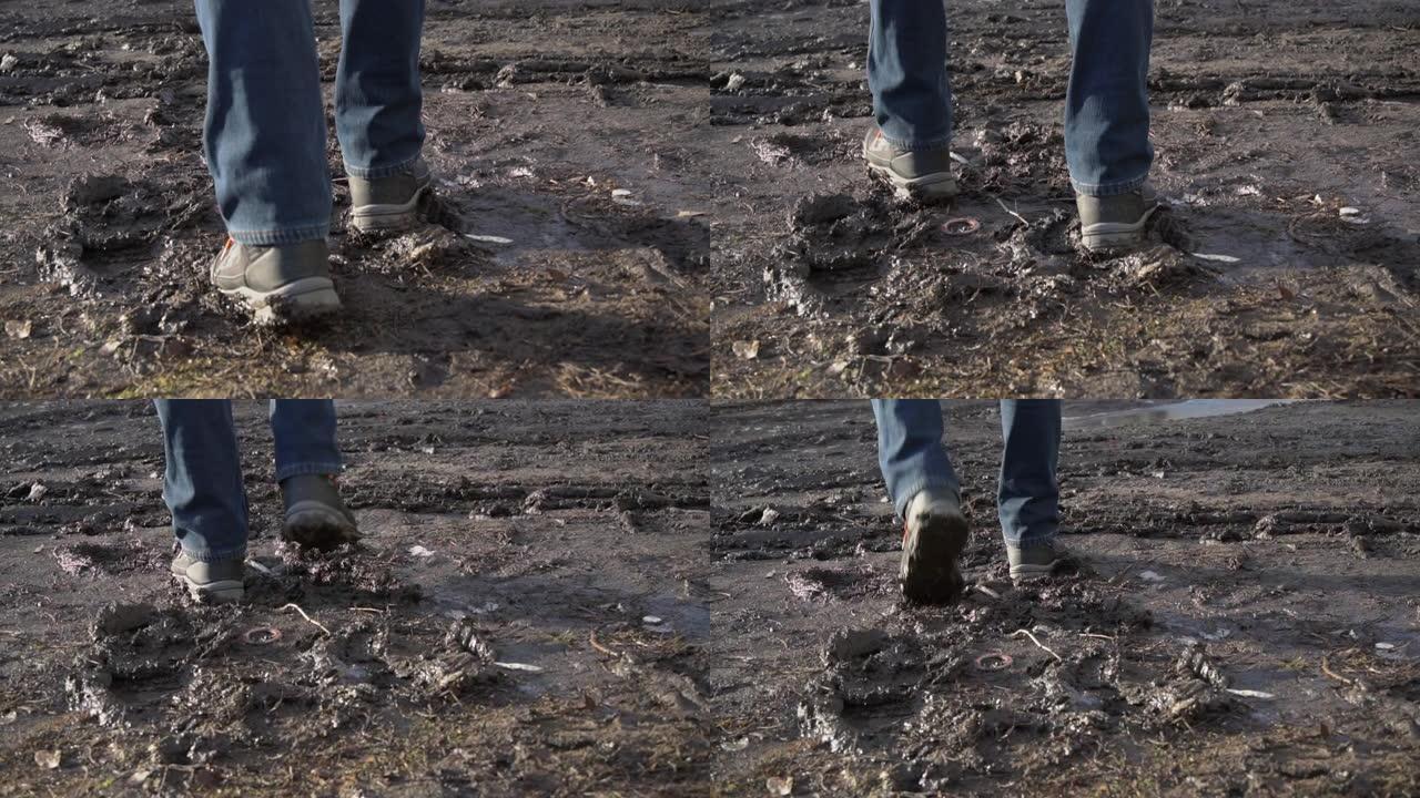 穿靴子的人走过泥泞，从Slowmo的水坑里溅起