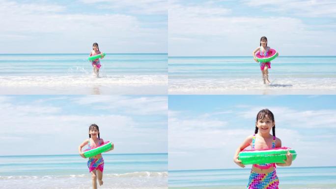 4k亚洲小女孩在夏日晴天在热带海滩上奔跑和玩耍的肖像。