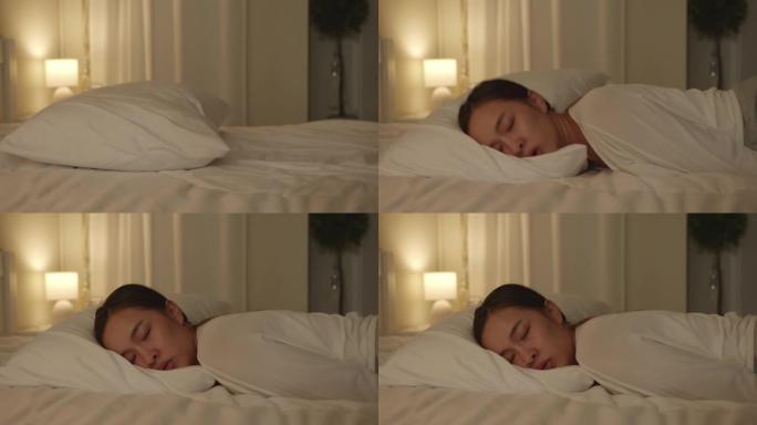 久经考验，疲惫不堪的年轻亚洲妇女晚上躺在床上