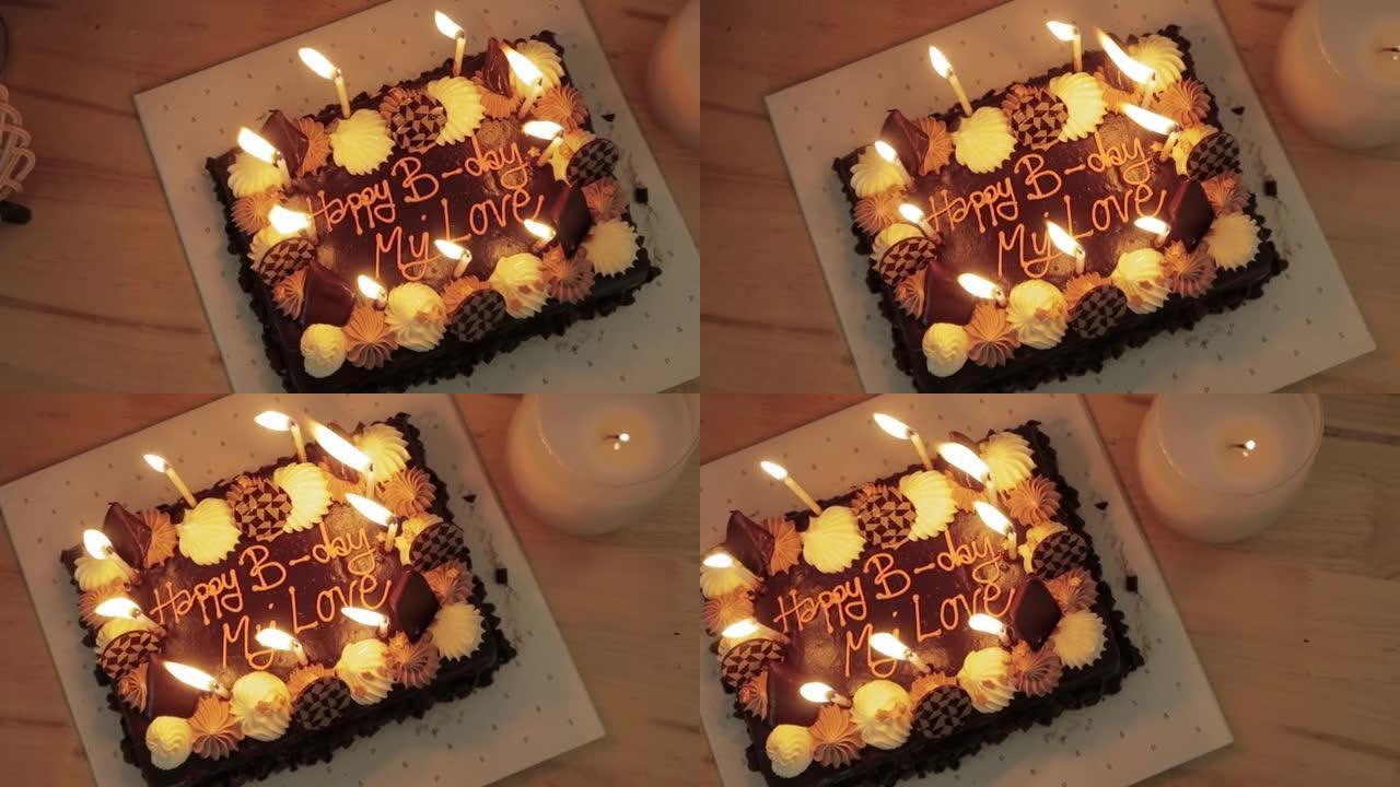 生日时在巧克力蛋糕上点燃蜡烛