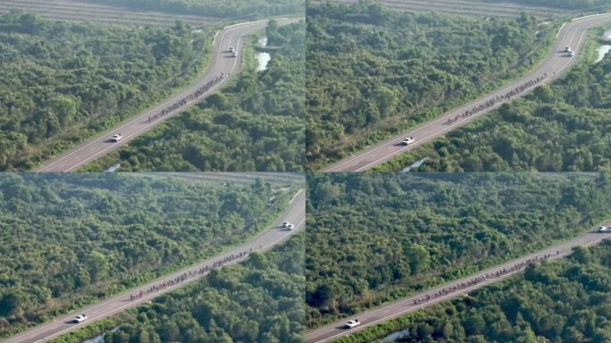 在泰国宋卡府乡村某处的道路上骑自行车的空中射击组