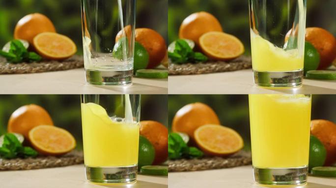 在绿色自然背景上倒橙汁。有机柑橘汁特写。健康的饮食习惯，烹饪成熟水果的鸡尾酒。