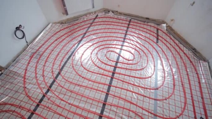 安装用于水加热的地板下加热管道。供暖系统。隔热地板用管道。