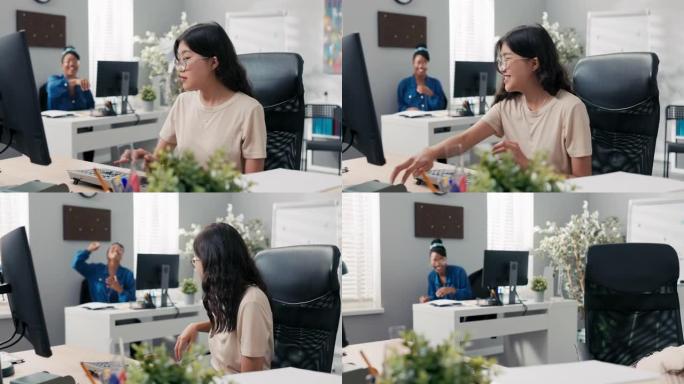 上班族坐在电脑前的办公桌前，在韩国美女的女人周围闲逛。另一个女孩因向同事扔纸飞机而感到不安