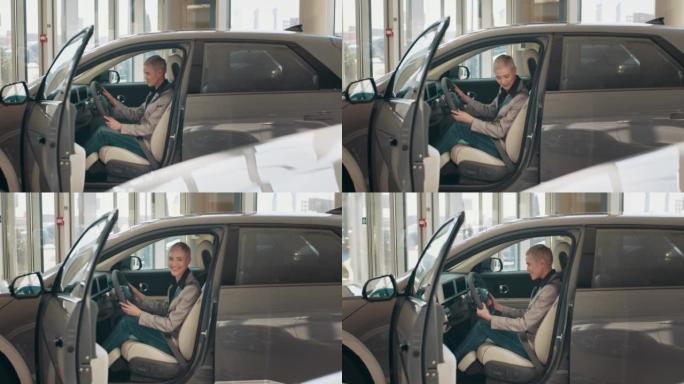 生态汽车销售概念。具有自动驾驶系统的新一代电动汽车的试驾。迷人的白人妇女坐在新现代汽车的方向盘后面。