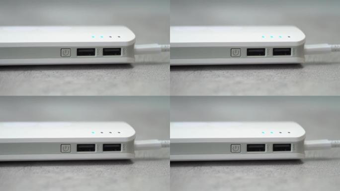 带有闪烁指示灯的powerbank特写。外部电池为电子设备充电