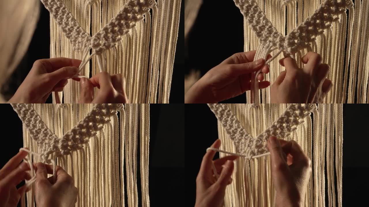 一位女工匠在她的家庭车间里用轻棉线编织macrame。女人的手打结创造了一条线。手工制作的概念。创意