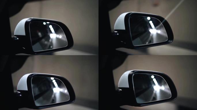 隧道灯在汽车的后视镜中反射。运动中的射击