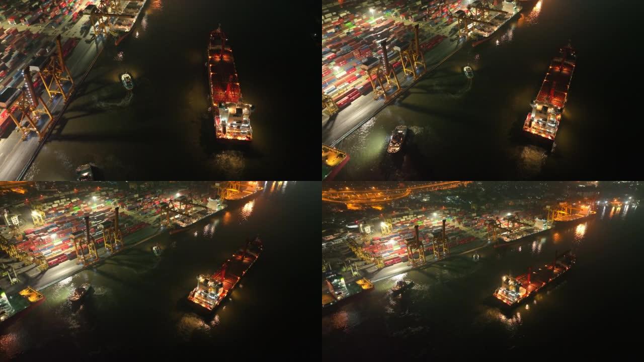 在泰国曼谷的日出场景中，空中无人机拍摄了码头上的一艘货船港口，吊臂下降到适当位置以卸下集装箱