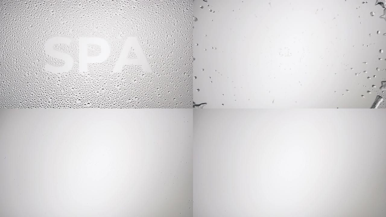 灰色背景上湿玻璃上的温泉字被吹走