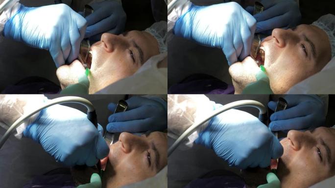 在治疗口腔之前使用麻醉剂注射的牙医。在牙科诊所给病人注射。为年轻人安装牙科植入物。特写。