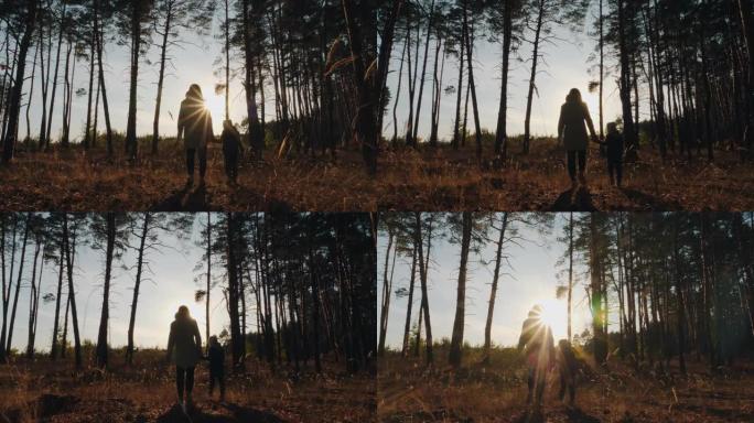 一个女人和一个孩子走过森林的剪影