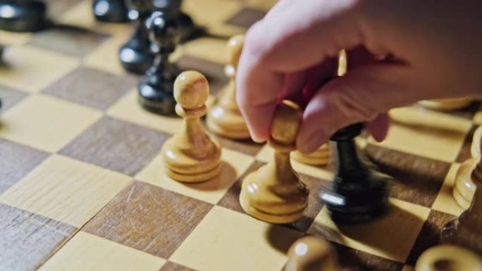 白卒在下棋中被白卒俘获主教。在棋盘游戏中手拿棋子的人