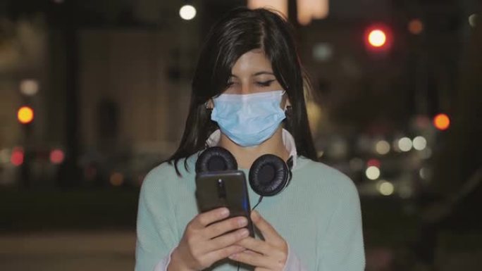 技术，带面具的智能手机女孩选择在手机上收听的歌曲