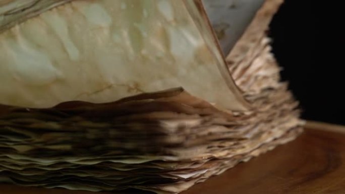 书籍或书法旧纸的翻页。翻转黄色古代羊皮纸。写作、学习和教育理念。用于书籍制作的纸。