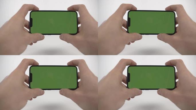 男人使用带有绿色模拟屏幕的电话，上网冲浪，观看内容