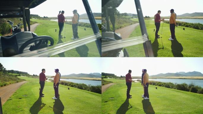 男性高尔夫球手在阳光明媚的高尔夫球场发球盒上聊天