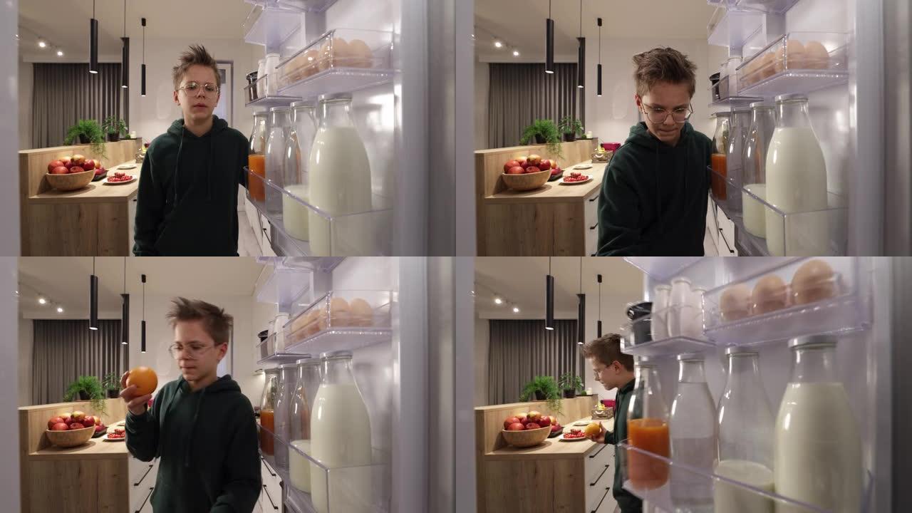 十几岁的男孩从冰箱里拿出橘子。